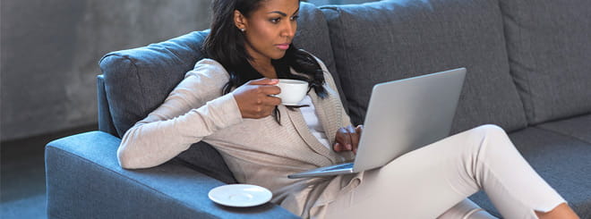 Woman on a couch with her laptop
